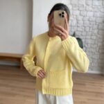 Yellow knit cardigan with cable details