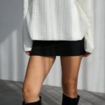 White knit sweater with a satin bow at the neckline